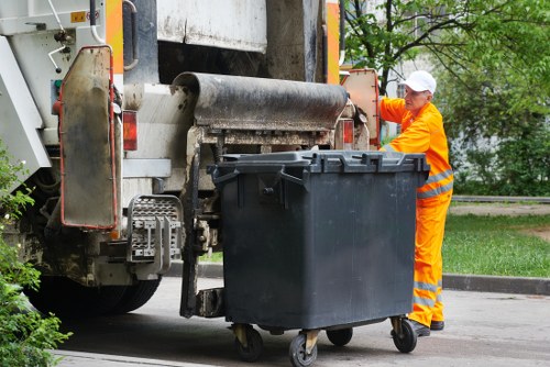 Small flat clear-out items being loaded into a van near a high street